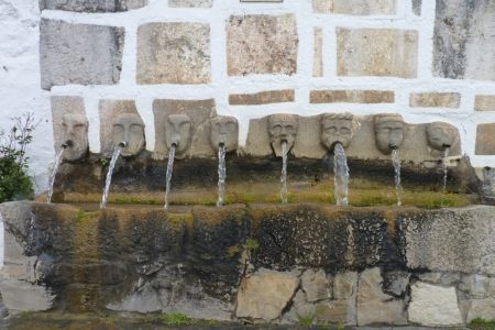 Römischer Brunnen in Grazalema mit insgesamt acht Fontänen mit individuell gestalteten menschlichen Gesichtern.